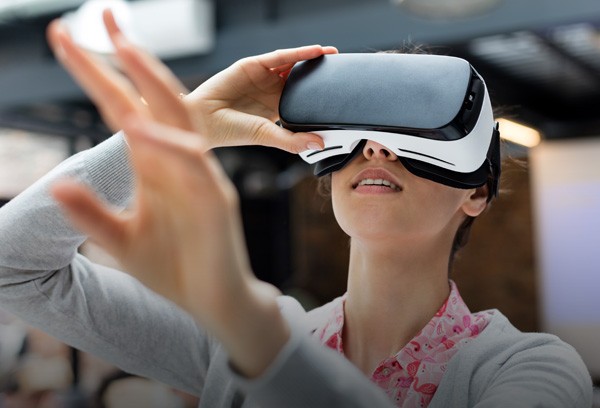 Woman reaching out while using VR glasses